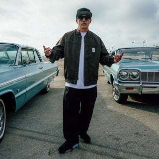Male model in front of classic lowrider car