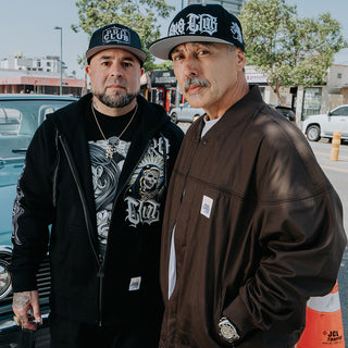 Pair of male model posing in front of classic lowrider