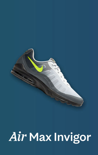 Gray and white sneaker with a green swoosh logo on a blue background, labeled 'Air Max Invigor'.