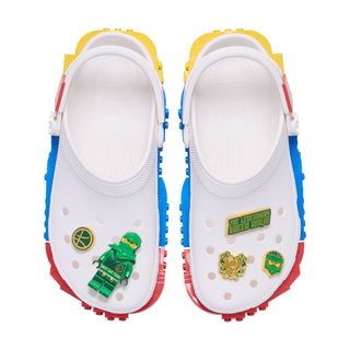 White Crocs with green Ninjago Lloyd Jibbitz charms on the shoe straps