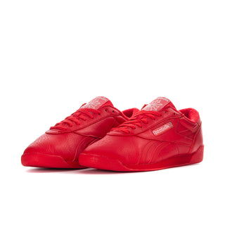 Women’s red Reebok low-top sneaker, side view with lace-up design