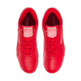 Women’s red Reebok low-top sneaker showing laces and cushioned tongue