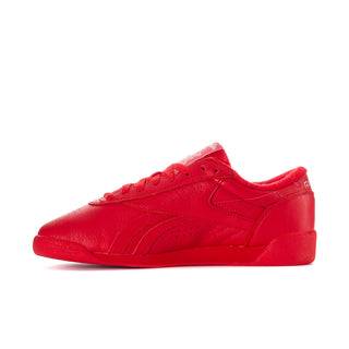 Women’s red Reebok low-top sneaker, front side profile with lace-up closure
