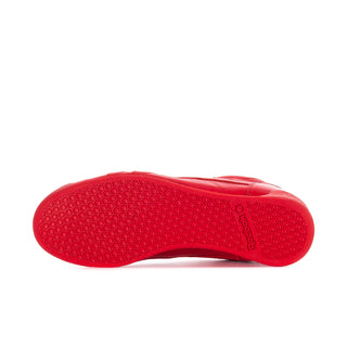 Women’s red Reebok sneaker outsole view with textured traction pattern