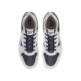 Youth sneakers close-up: Reebok tongue label, lace-up with navy eyelets