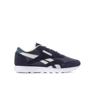 Youth Reebok sneakers side view, dark indigo with white stripe and lace-up