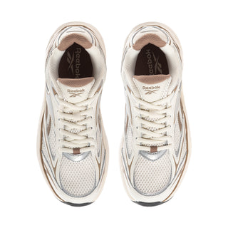 Pair of off-white lace-up sneakers with mesh panels, Reebok logo on tongue
