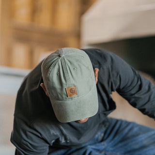 Olive canvas dad cap with Carhartt leather patch and curved brim