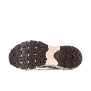 Women’s pink running sneaker outsole view with treaded rubber and cream midsole