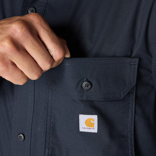 Navy button-front shirt pocket detail with Carhartt logo patch