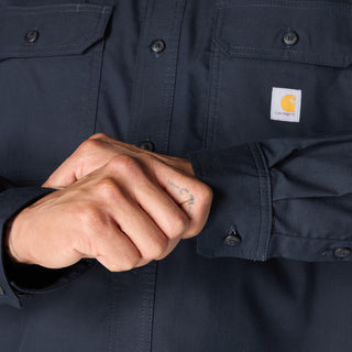 Navy long-sleeve shirt cuff and placket detail with logo patch