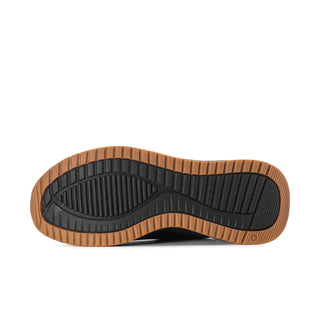 Black outsole tread with gum border on men's slip-on sneakers