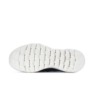 Women's navy slip-on sneaker outsole view with tread pattern on white rubber