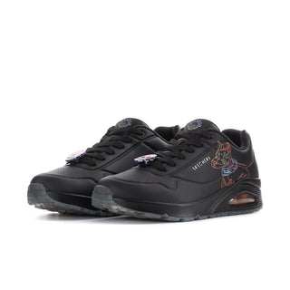 Men's black low-top sneakers, side view, with colorful skull and orange accent