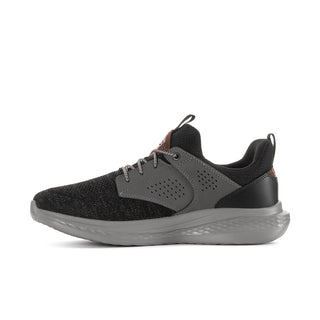 Side view of a men's black knit sneaker with charcoal panels and a cushioned gray sole