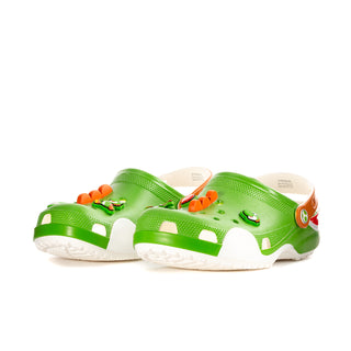 Bright green clogs with orange accents, white soles, and character charms on top