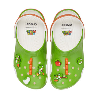 Green clogs showing white interior footbeds with printed character graphics