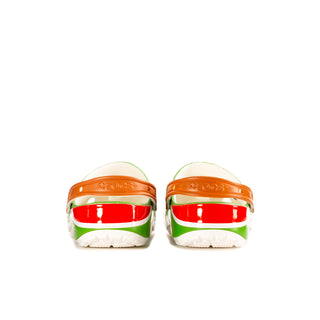 Green clogs from heel view with orange back strap and red band
