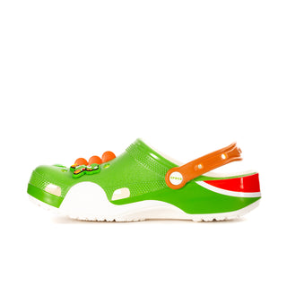 Green clog with orange strap, red-and-white side panel, and character detail