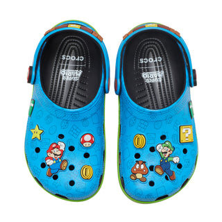 Pair of youth blue clogs with black footbeds, cartoon graphics, round vents.