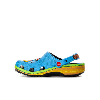 Youth blue clog with crocs logo, colorful cartoon front, green/yellow sole.