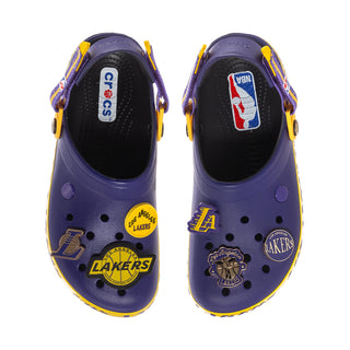 Pair of men's purple Crocband clogs with yellow details and Lakers team patches.