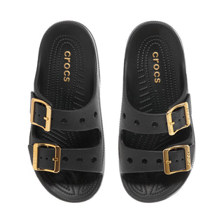 Women's black sandals with gold buckled straps and Crocs logo on footbed
