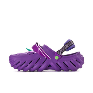 Men's purple clog with black strap, green button accent, and side cutouts