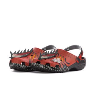 Men's orange clog side view with black spikes, black sole, and character design