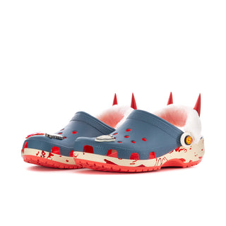 Women’s blue clog pair with white faux-fur lining, red spikes, and red outsole trim