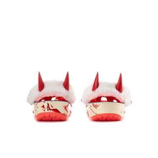 Women’s blue clog back view with white faux-fur lining and red spike accents