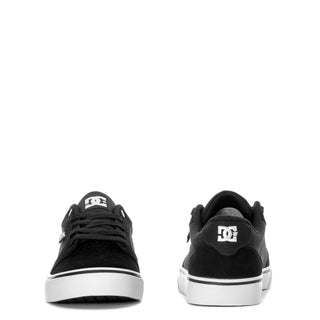 Men's black low-top sneakers from back with white heel stripe and logo patch