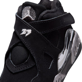 Toddler black sneaker close-up with stitched trim and silver side graphic