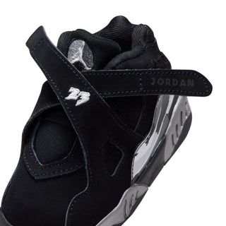 Toddler black sneaker close-up with strap, JORDAN branding, and silver side panel