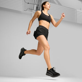 Black running sneakers on a jumping stride, lace-up front
