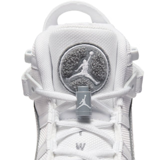 Youth sneaker tongue patch with Jumpman emblem on white fabric.