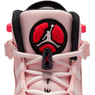 Close-up of pink sneaker heel with black circular patch and red Jumpman graphic