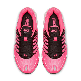 Womens pink Nike Air Max Torch 4 shoes, black laces, tongue shows Nike Torch 4 branding