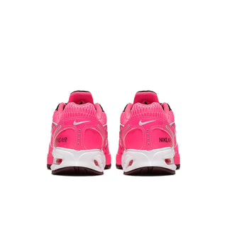 Womens pink Nike Air Max Torch 4 sneakers, rear view with white midsole and red heel accents