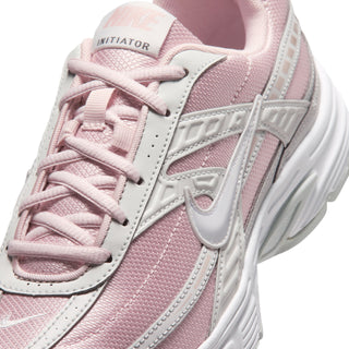 Women's sneaker upper close-up, light pink mesh, gray Swoosh logo, lace-up