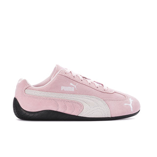 Pink low-top sneakers with Puma logo, white stripes, and black rubber sole