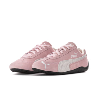 Pair of pink and white low-top Puma sneakers with laces and black sole