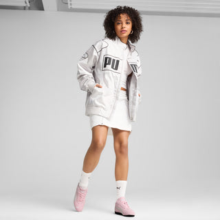 Pink Puma sneakers worn with a short white dress and white socks