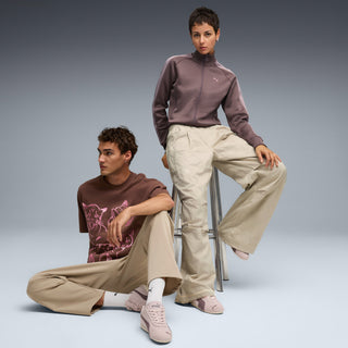 Mauve sneakers on models' feet with light trousers, Puma side logo visible