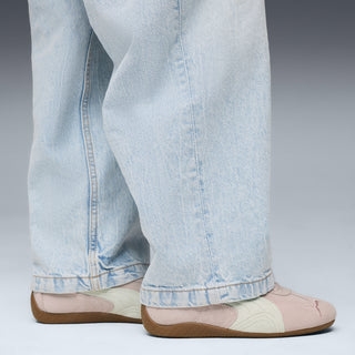 Youth sneakers shown with light blue jeans cuffs, mauve-and-white low-top and gum sole