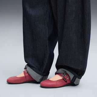 Red mary jane ballet flats worn with rolled dark jeans and gray cuffs