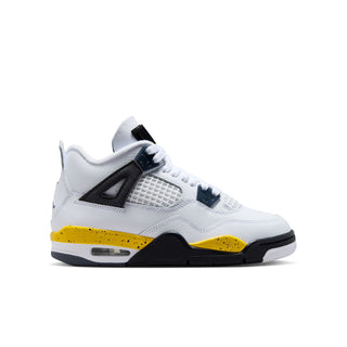 Youth low-top sneakers in white with black accents and yellow outsole detailing.