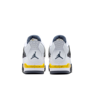 Youth white sneakers with black heel tabs, Air Jordan logo, and yellow accent strip.
