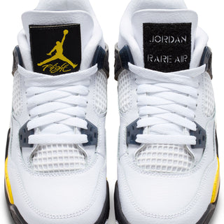 Back view of youth white sneakers with black heel labels reading JORDAN and RARE AIR.