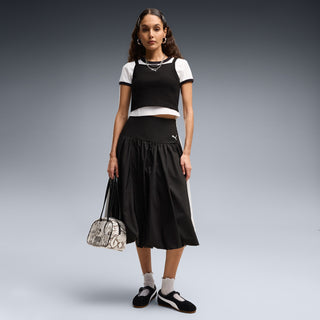 Women's black suede Mary Jane shoes with white stripe, worn with dark skirt